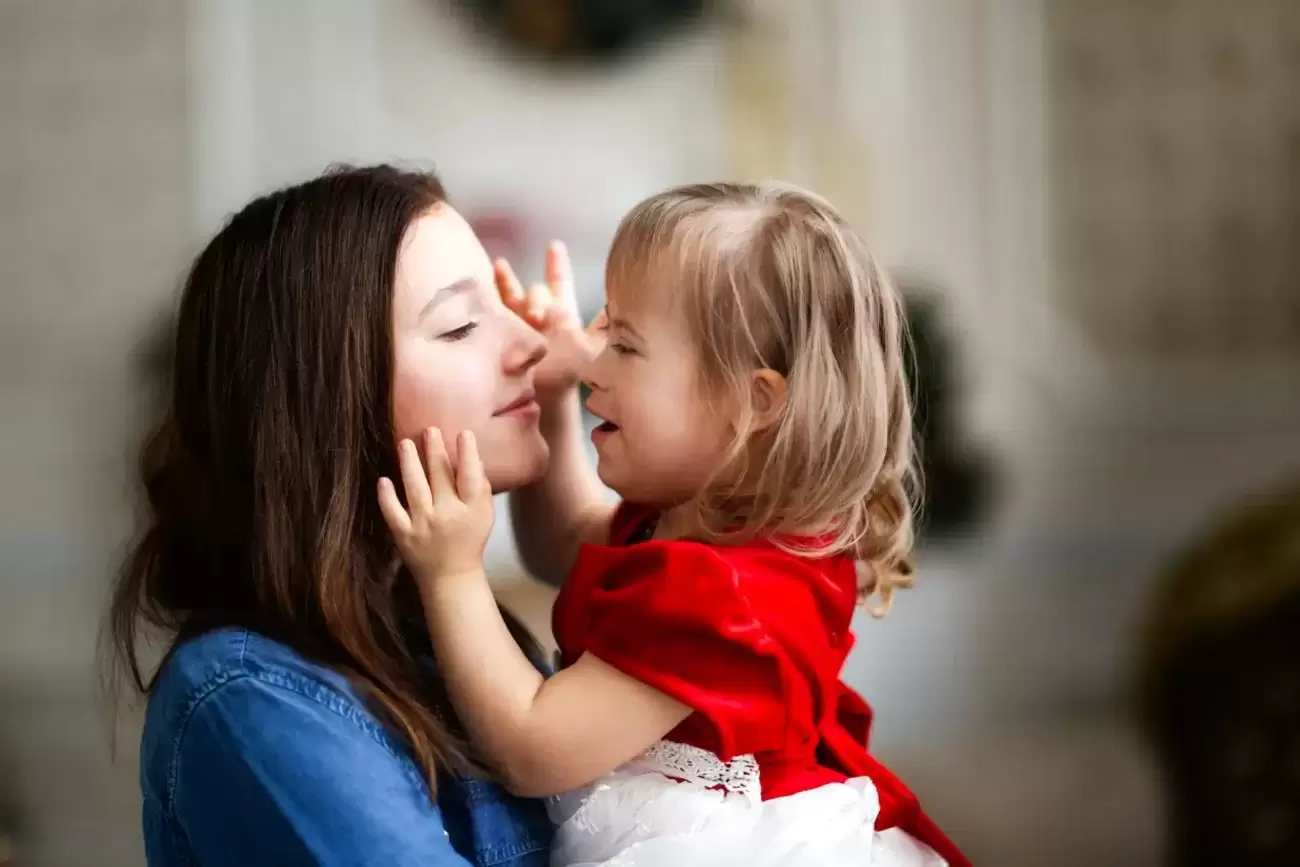 A foster bay kissing a foster mother
