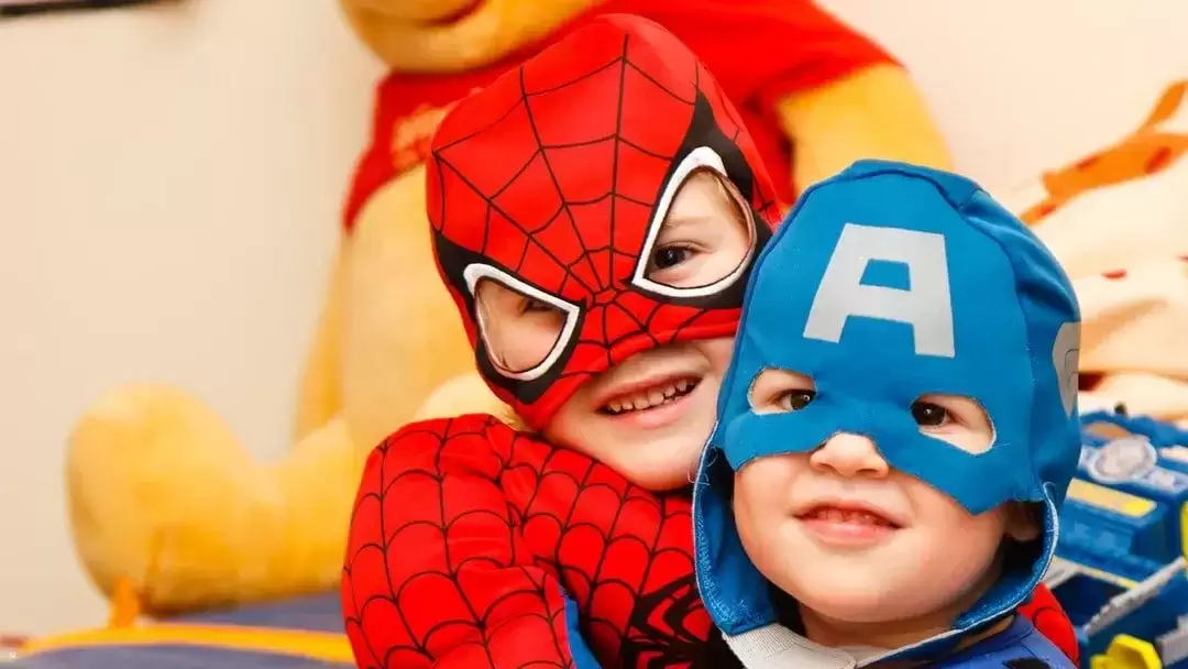 Two foster children dressed as superheroes.