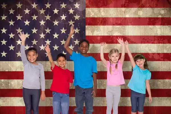 Foster children standing in front of an American flag