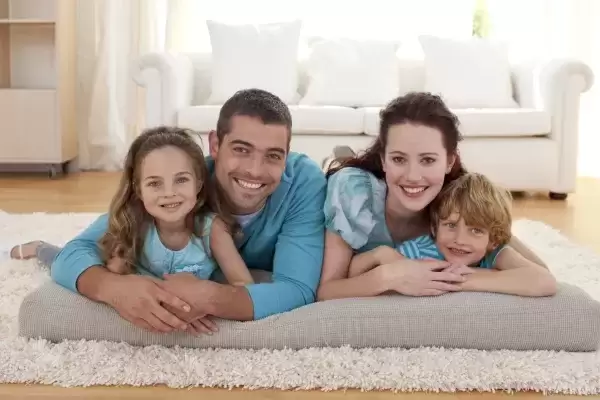 foster family with two kids on a rug