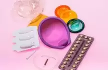 Contraception devices on a pink background